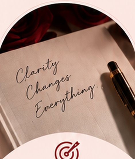 An open journal on a linen table beside a gold pen, the words clarity changes everything written in script
